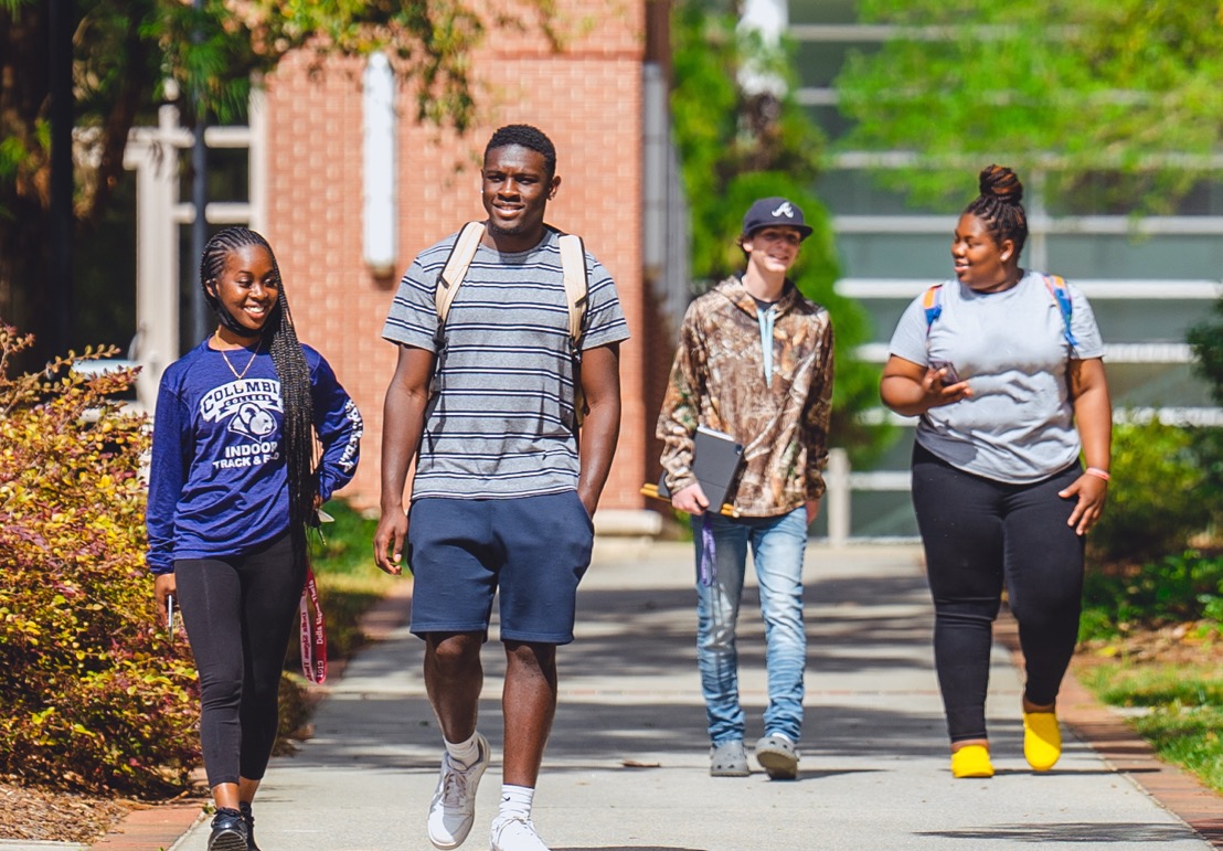 students in group walking on campus